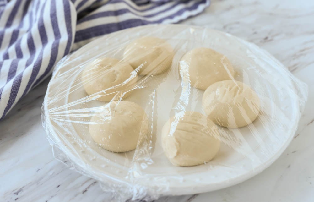 rolls on a plate covered with plastic wrap