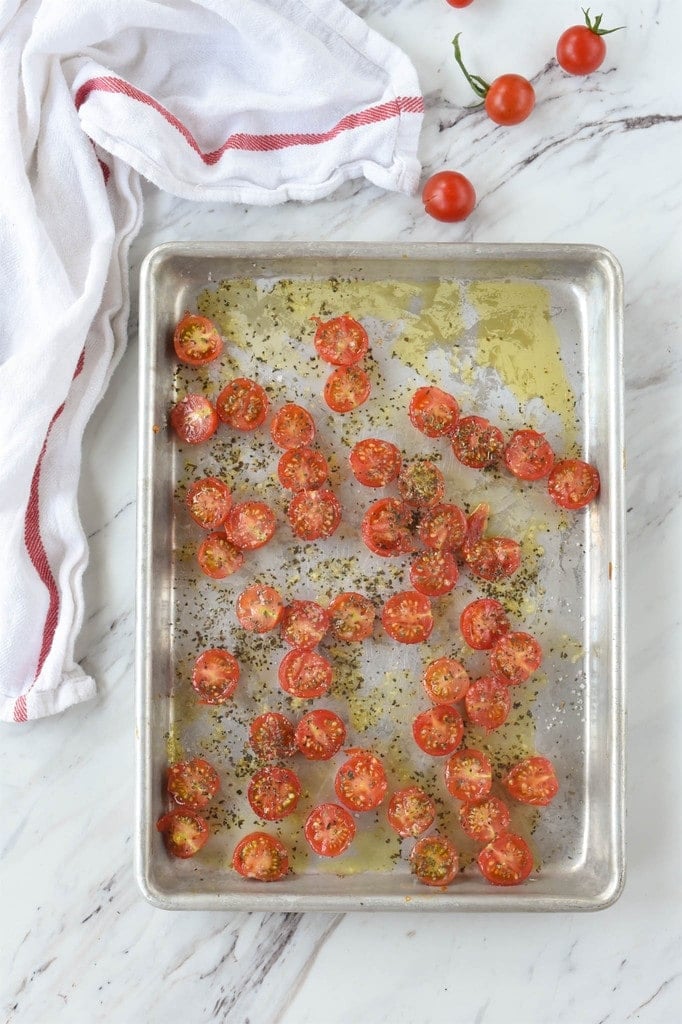 sliced tomatoes on a roasting pan 