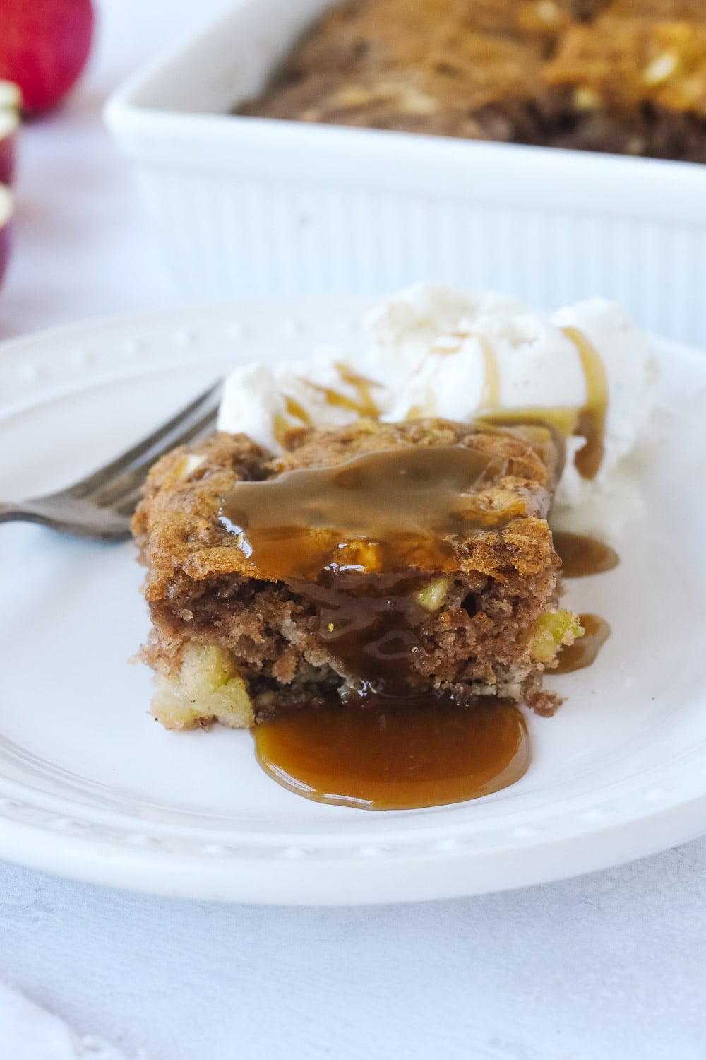 piece of apple cake with caramel sauce and ice cream