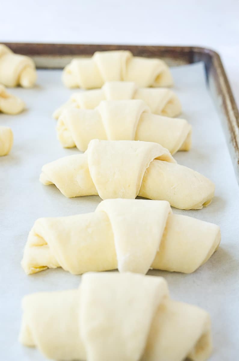 crescent rolls rising on baking sheet