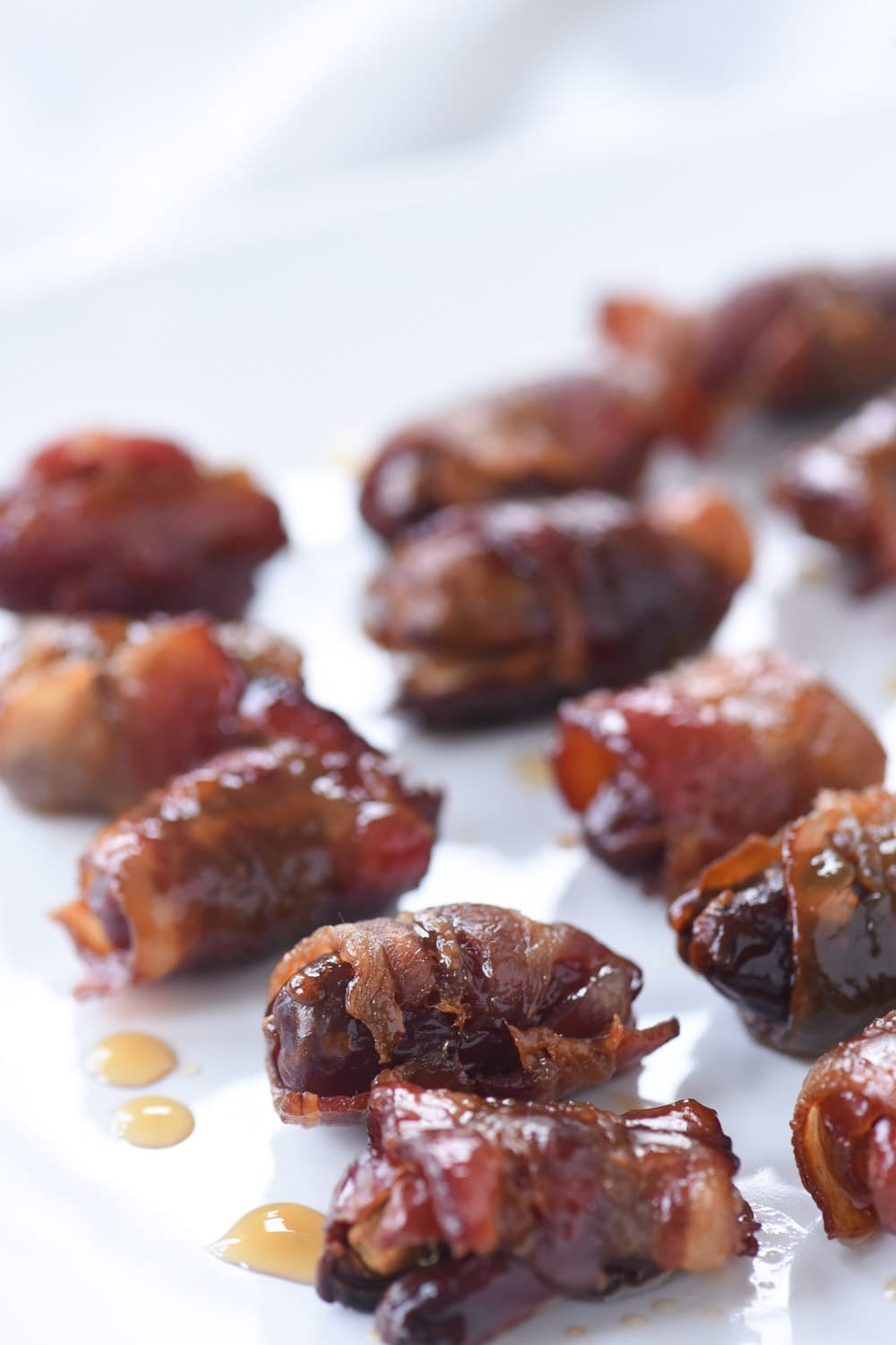 bacon wrapped dates on a plate