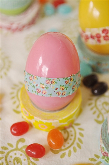 pink plastic easter egg with washi tape on it.