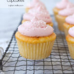 frosted pink cupcakes on a cooling rack