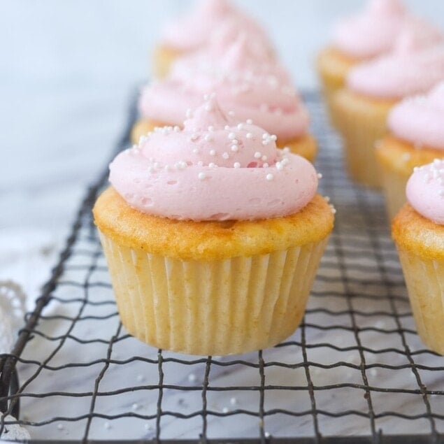 pink lemonade cupcakes on a cooling rack