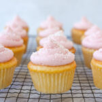 pink frosted cupcake on a rack