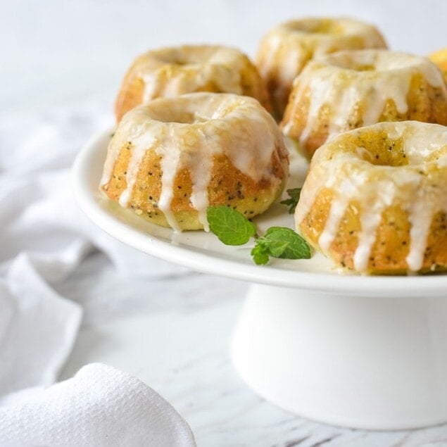cake stand with orange poppyseed bundt cakes