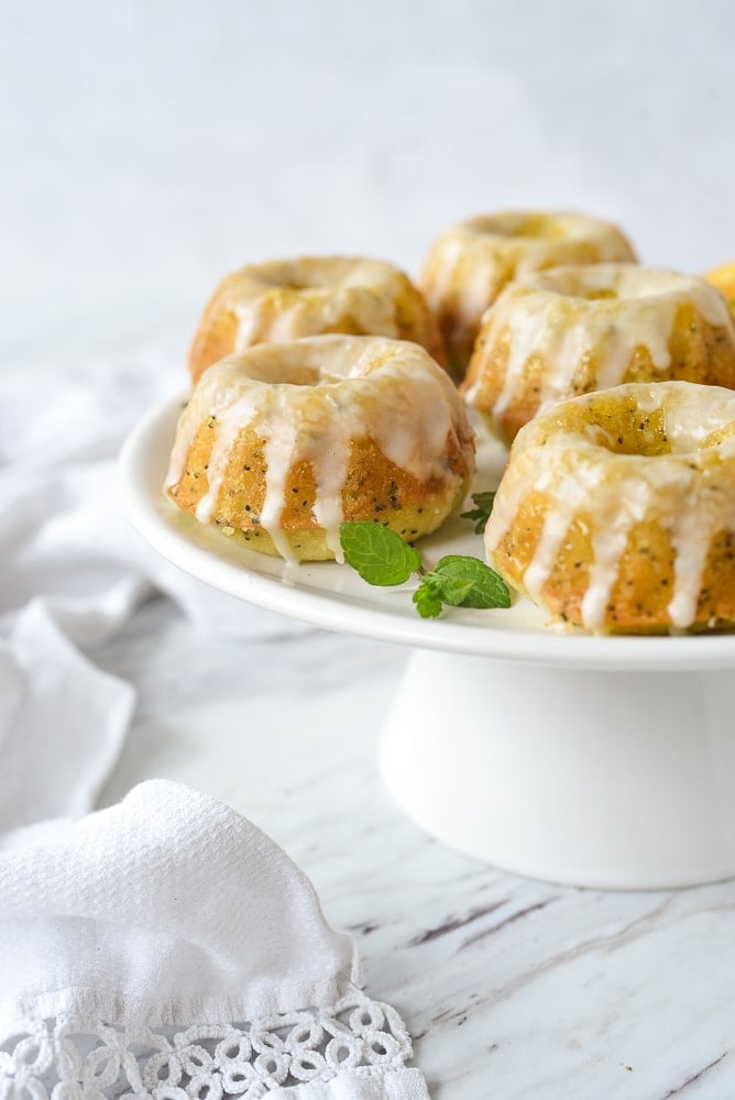 cake stand with orange poppyseed bundt cakes