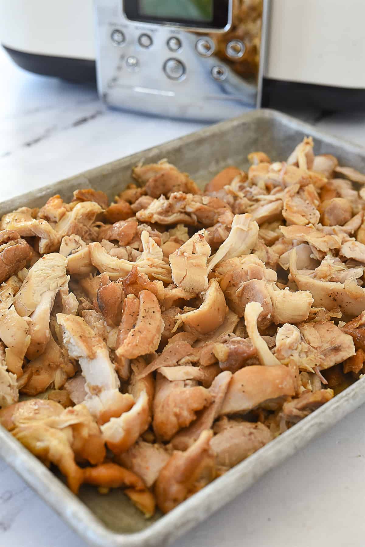 shredded chicken on baking sheet