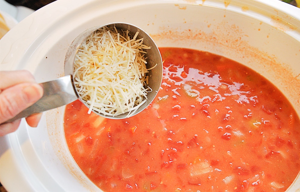 Crock Pot Tomato Basil Soup adding cheese into soup
