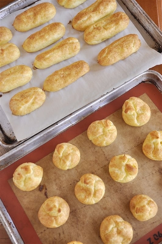 baked cream puffs on baking sheet