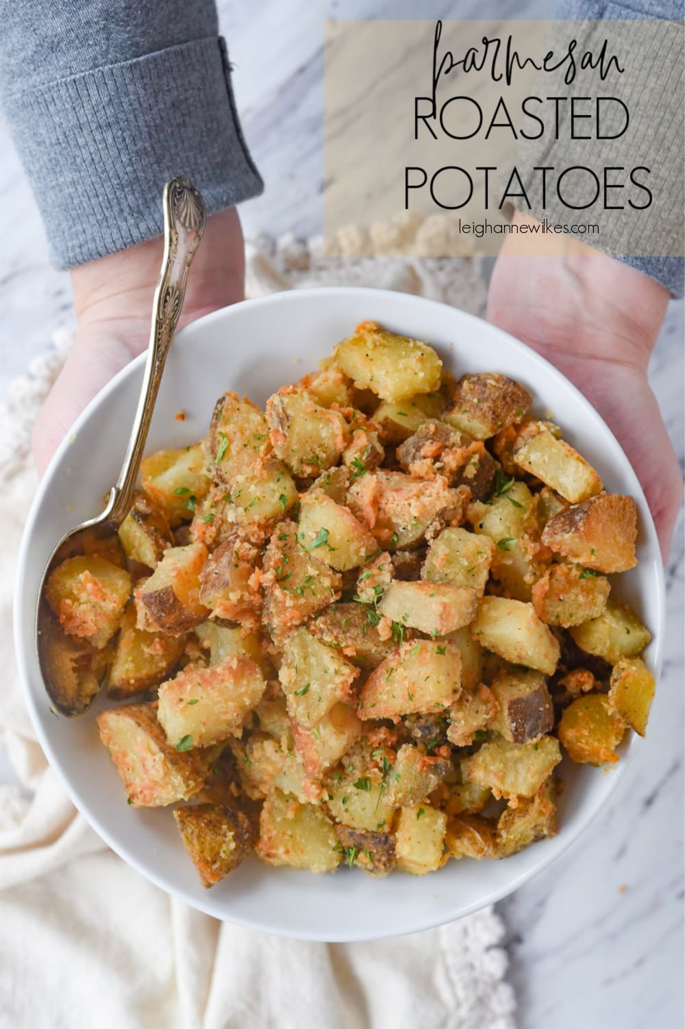 overhead shot of hands holding bowl of potatoes