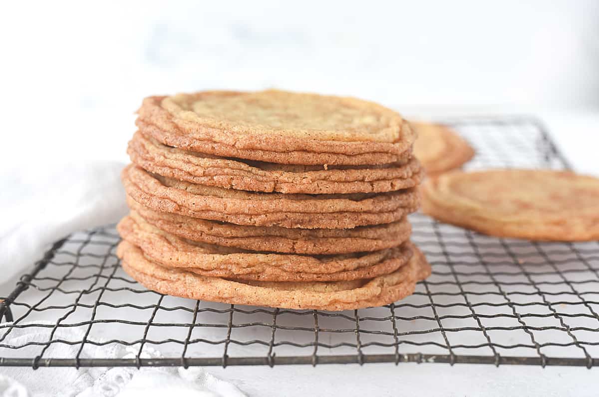 stack of snickerdoodle cookies on a cooling rack