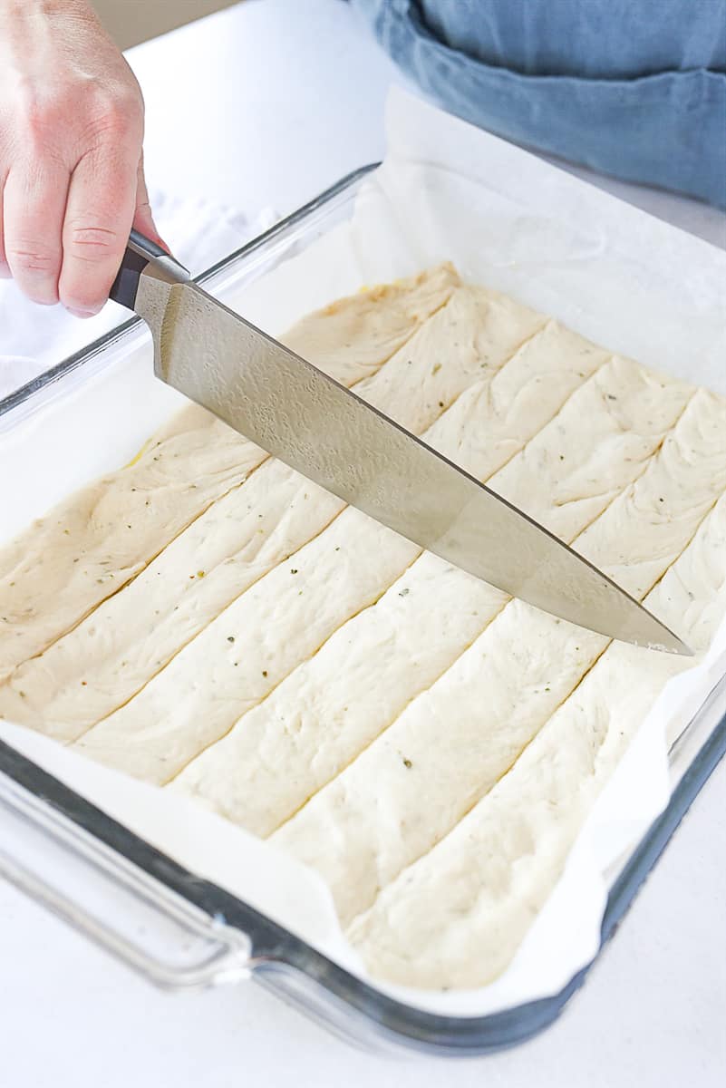 cutting lines into breadstick dough