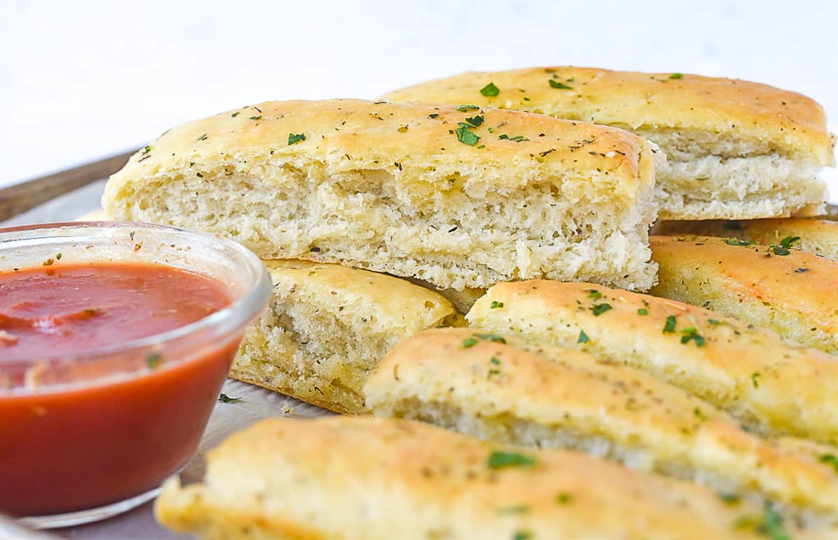 pile of italian breadsticks on baking sheet