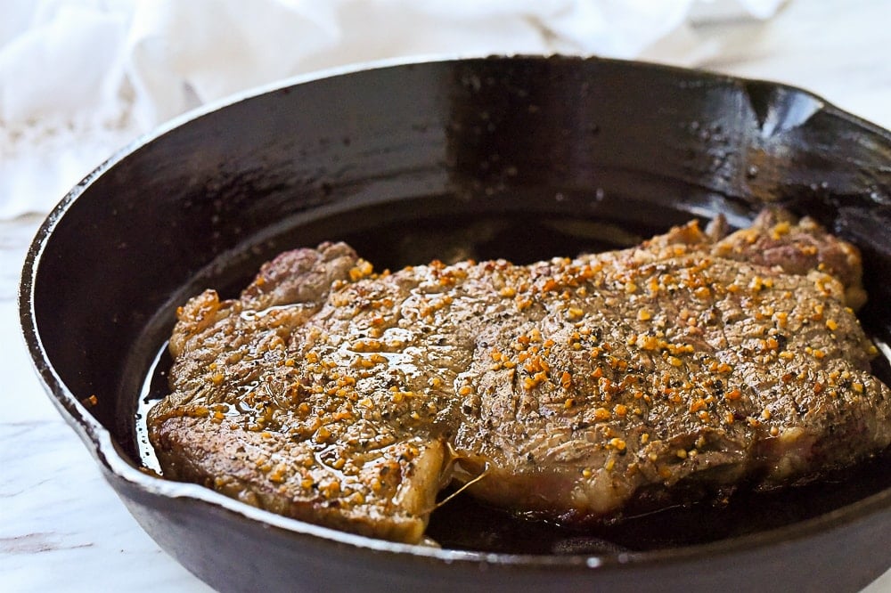 ribeye steak in a cast iron pan