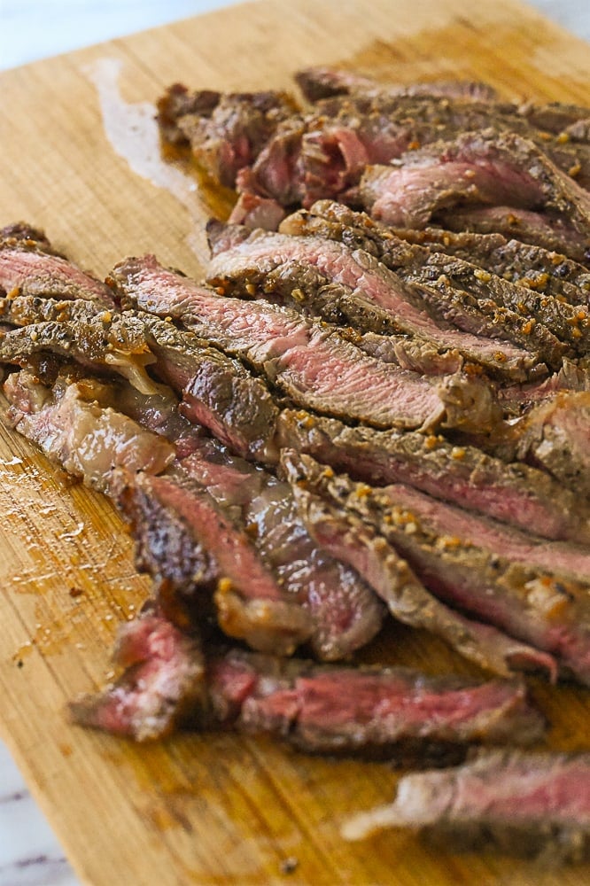 sliced steak on cutting board