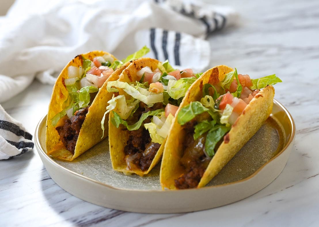 three baked tacos on a plate