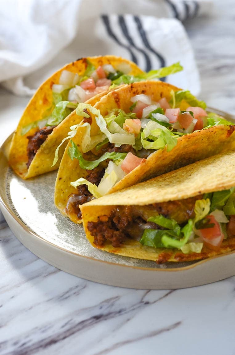 three baked tacos on a plate