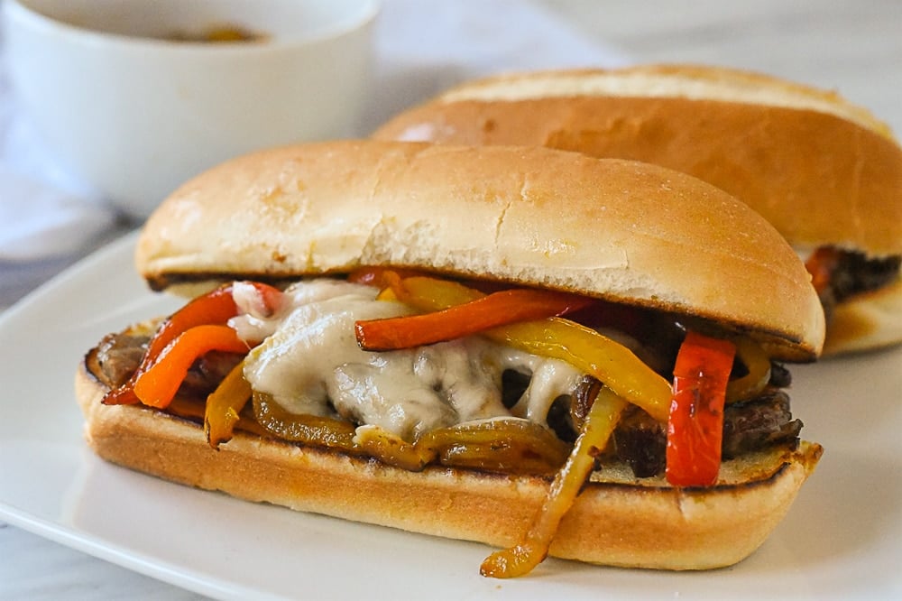 two philly cheesesteak sandwiches