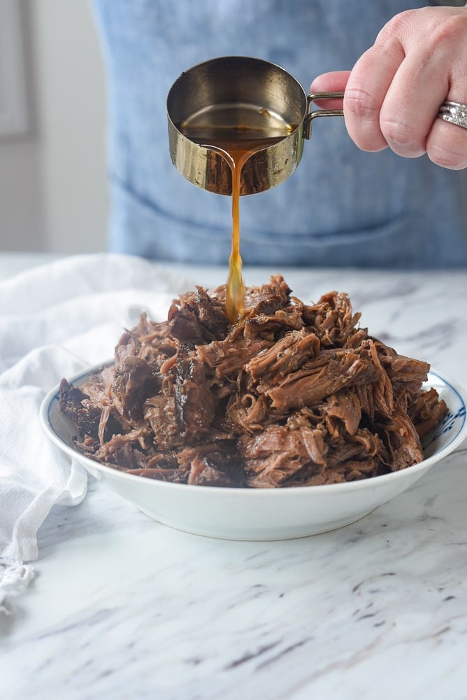 pouring juice over balsamic beef