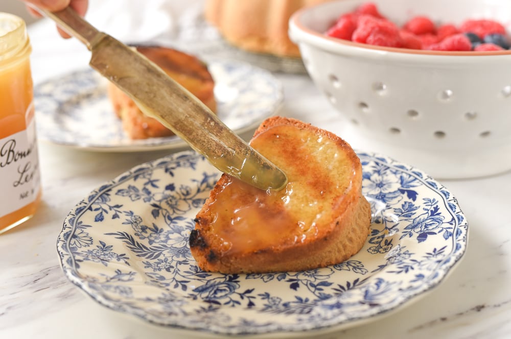 spreading lemon curd on pound cake