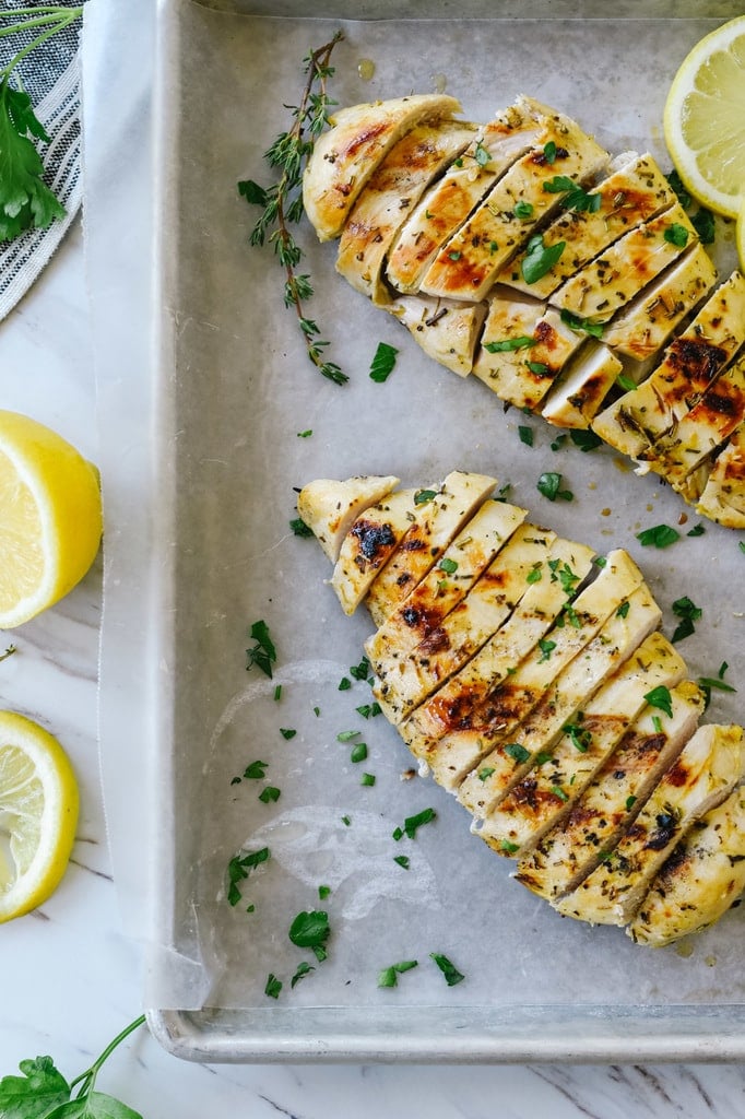 slices of lemon mustard chicken on a baking sheet