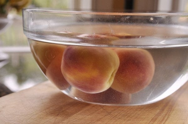 bowl of peaches in water
