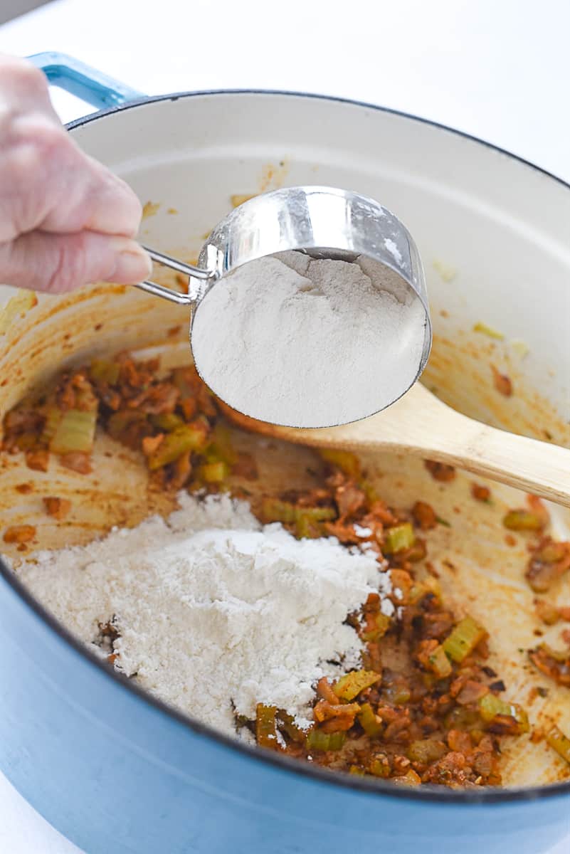 adding flour to soup