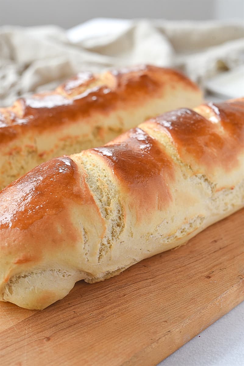 two loaves of french bread on a board