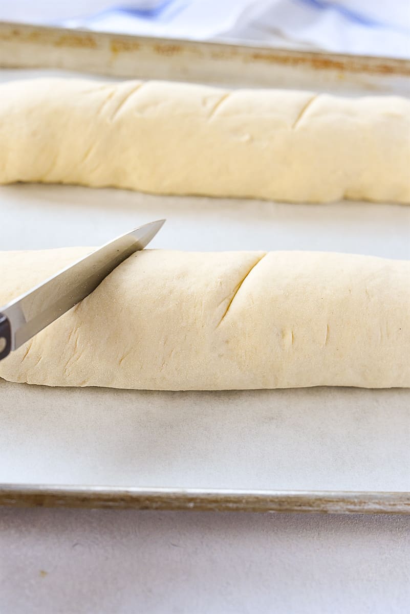 cutting slices into bread dough