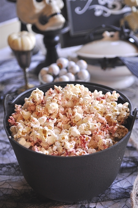 bloody popcorn in a black cauldron halloween party food