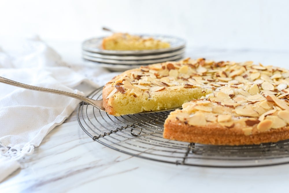 slice of almond torte on a cooling rack