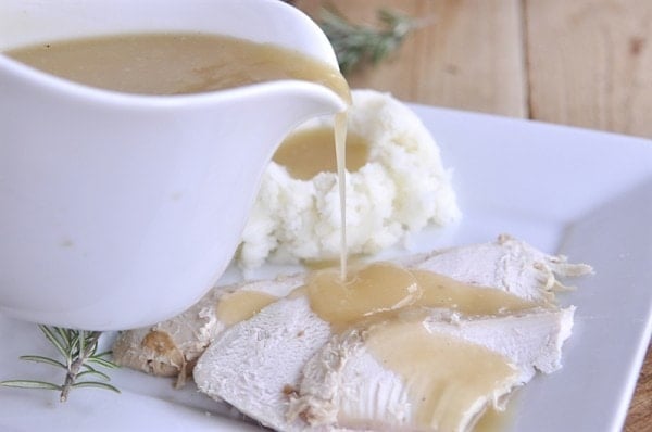 pouring gravy over slow cooker turkey breast