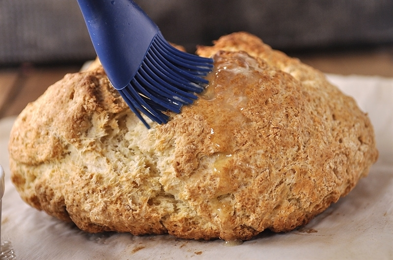 brushing soda bread with butter