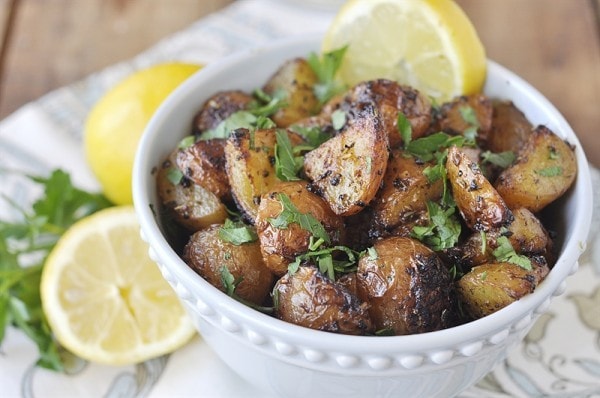 lemon roasted potatoes in a white bowl