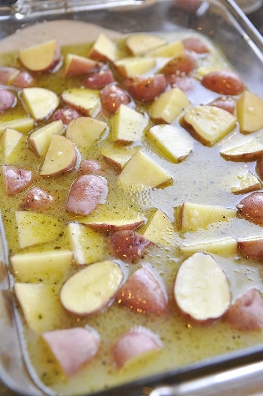 cubed potatoes in a pan full of lemon herb butter