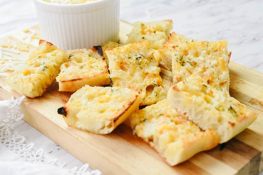 cheesy garlic bread on a cutting board