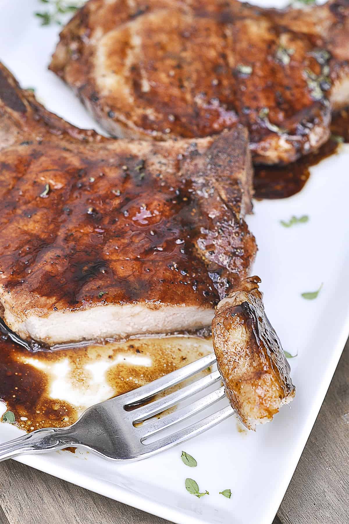 fork with a piece of pork chop on it