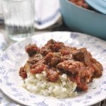 plate of swiss steak over mashed potatoes
