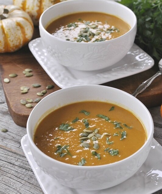 two bowls of pumpkin curry soup