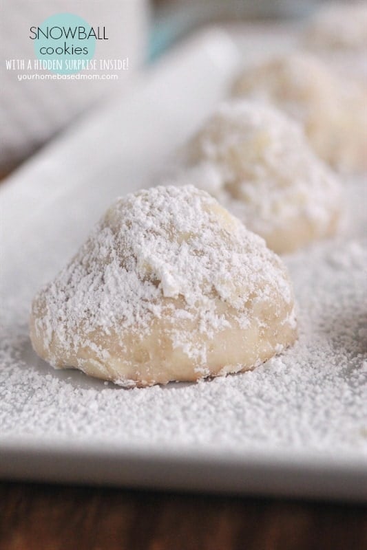 Snowball Cookies on a tray dusted with powdered sugar