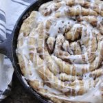 cast iron cinnamon roll in pan