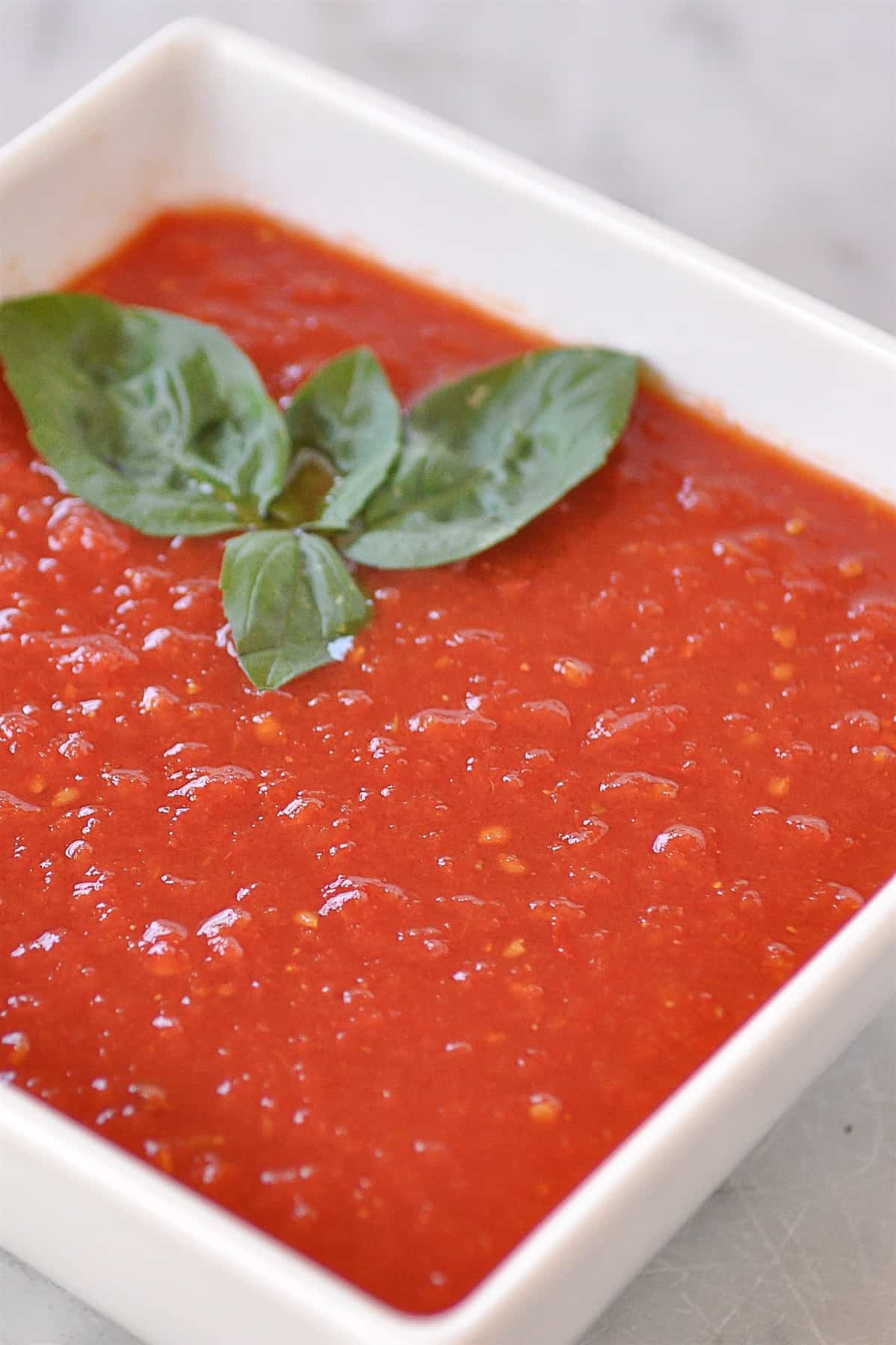 white bowl full of tomato sauce