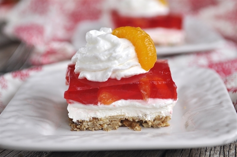 jello pretzel salad slice of Orange Cranberry Pretzel salad on white plate