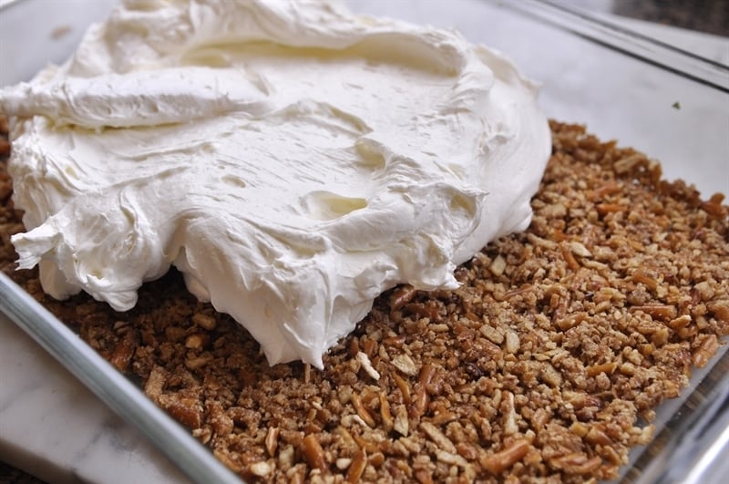 pretzel salad recipe whipped topping spread over a pretzel crust