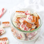 top of a jar full of white chocolate peppermint pretzels
