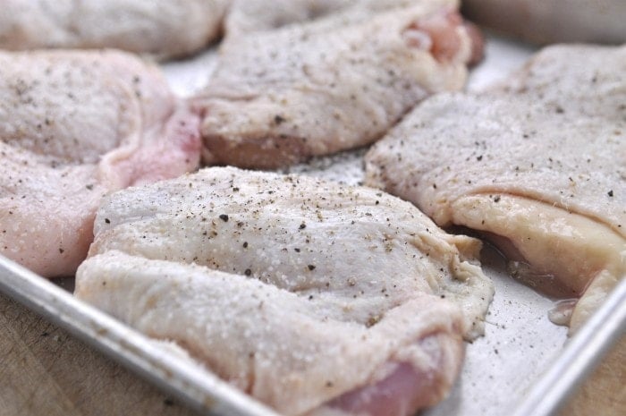 chicken thighs prepared with salt and pepper