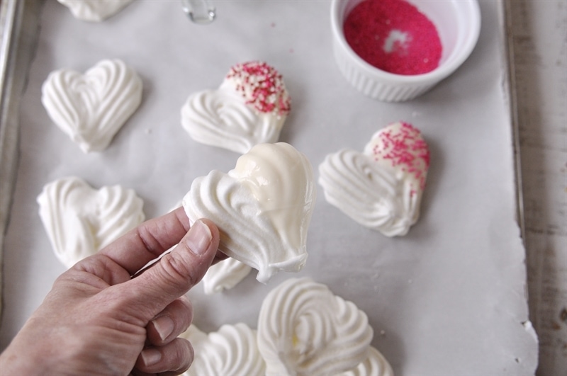 Meringue Hearts being dipped in chocolate