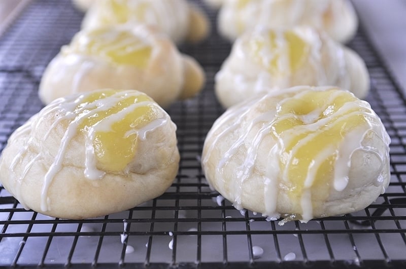 Lemon Curd Rolls with Lemon Drizzle on a cooling rack