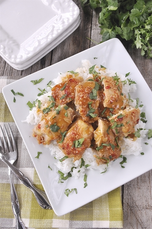 plate of citrus chicken garnished with cilantro